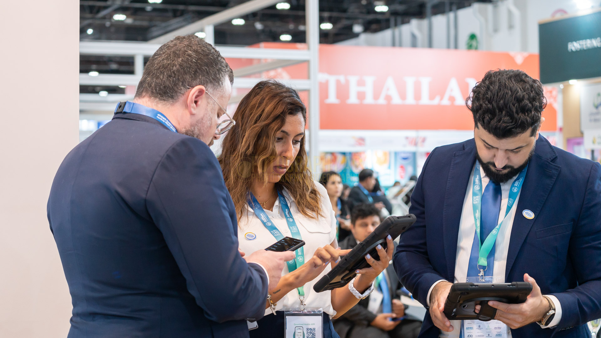 professional photograph of employees of oil and gas sector working at an Adnec Exhibition in abu dhabi.