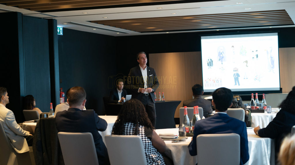 Professional event photographer capturing business leaders networking at a corporate event in Dubai, UAE.