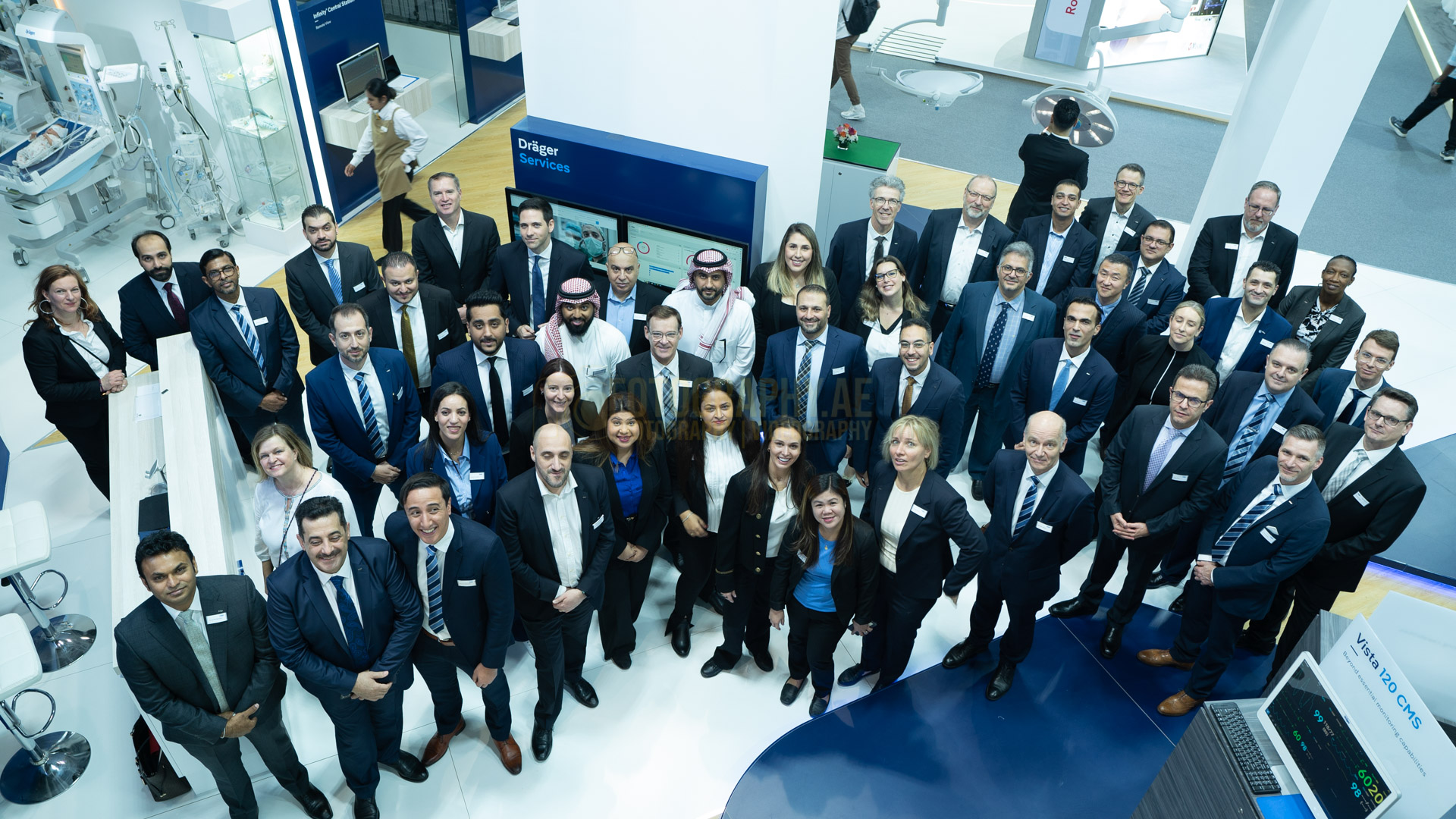 Professional group Photograph of corporate company employees in Dubai world trade center, posing for a group picture.