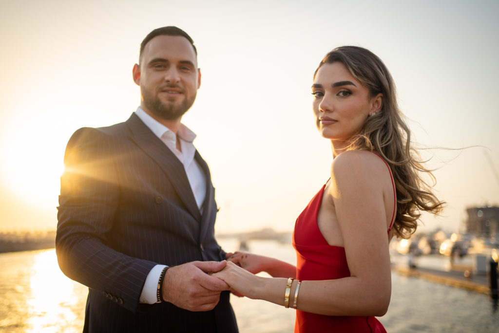 Professional Photograph of a couple posing on a yacht at sunset in Dubai.