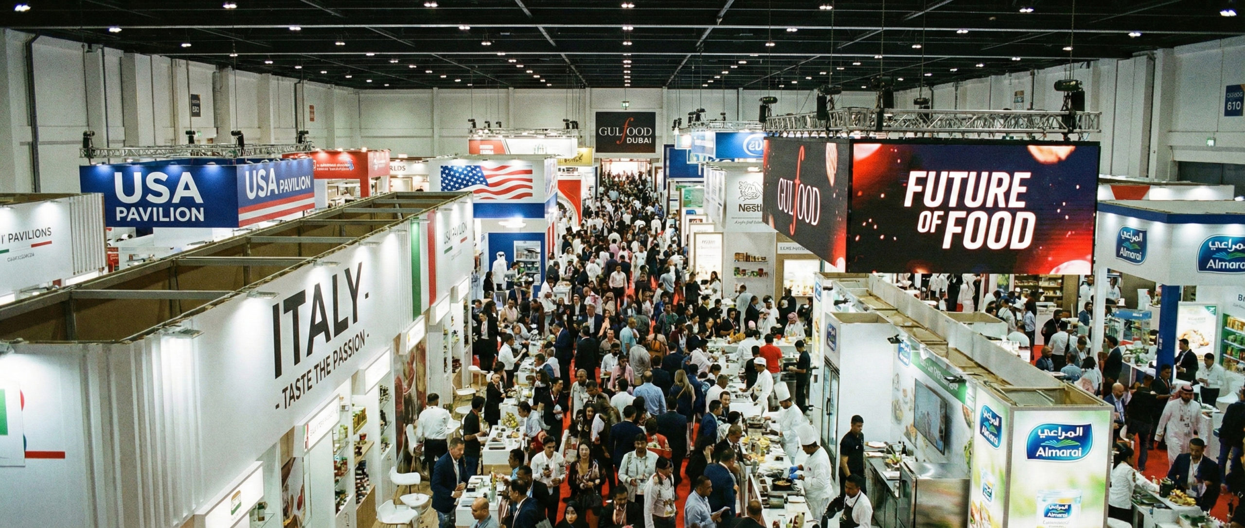 Wide-angle view of thousands of attendees filling the aisles between exhibition stands at a busy trade show in Dubai.